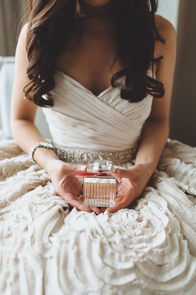 Bride holding her perfume.