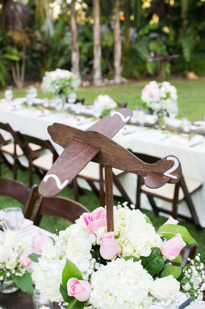 This pilot Groom and traveling couple crafted wooden airplanes for their table numbers and we love it!