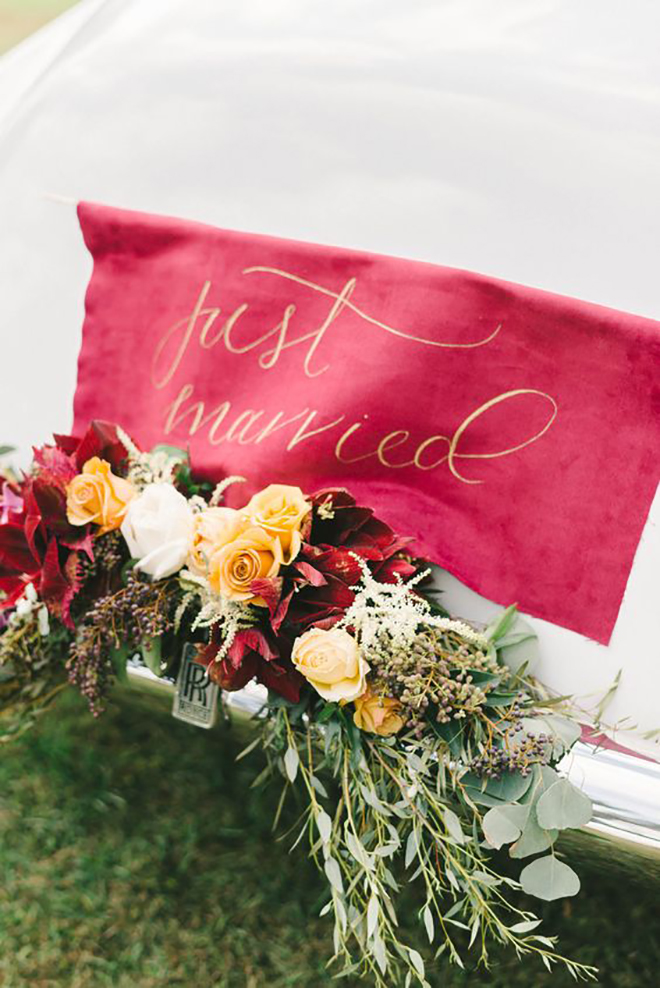 We love this punchy banner and swag decor for a wedding getaway car. 