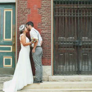 bride and groom in a doorway outside