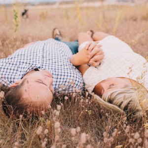 engagement shoot laying in the grass