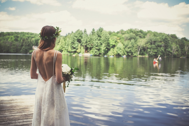 The bride waiting for her groom to arrive by canoe