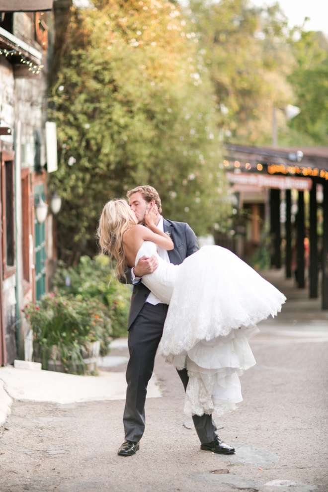 Groom lifting and kissing his bride!