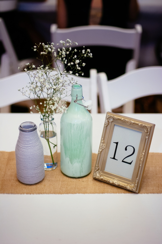 Painted bottle, yarn wrapped bottle and framed table number