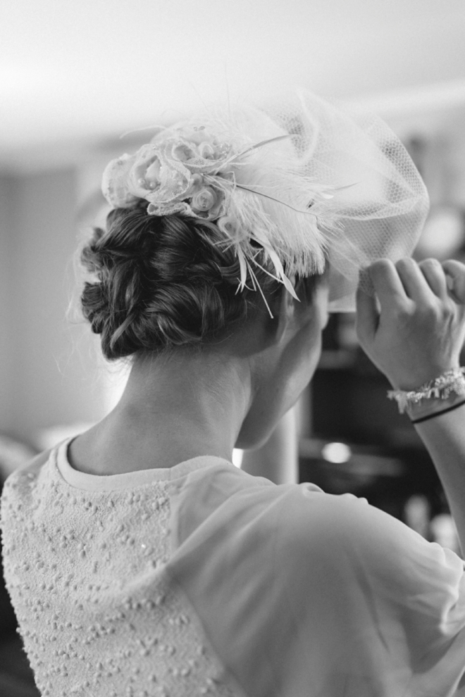 Bride putting on veil