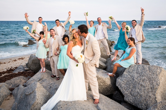 Beach wedding party on rocks