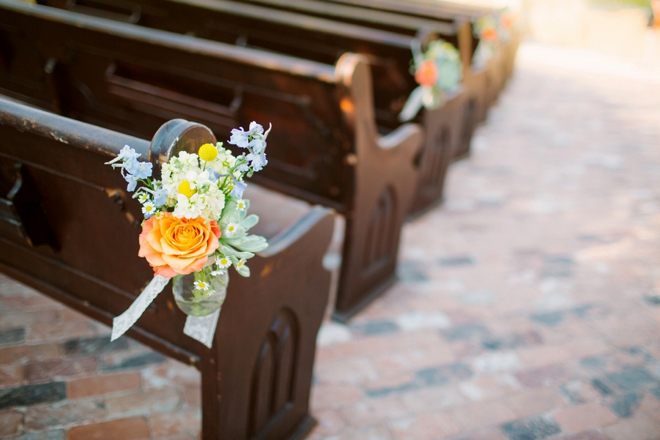 Outdoor pews decorated with flowers