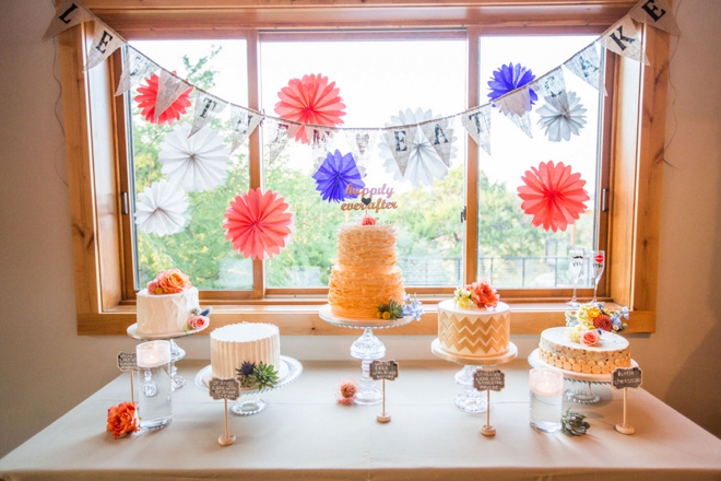 Colorful dessert table with multiple wedding cakes