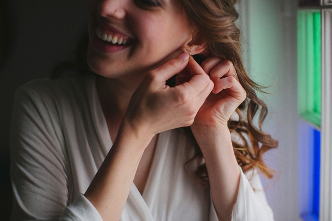 Putting on her jewelry