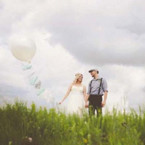 Bride and groom with large balloon