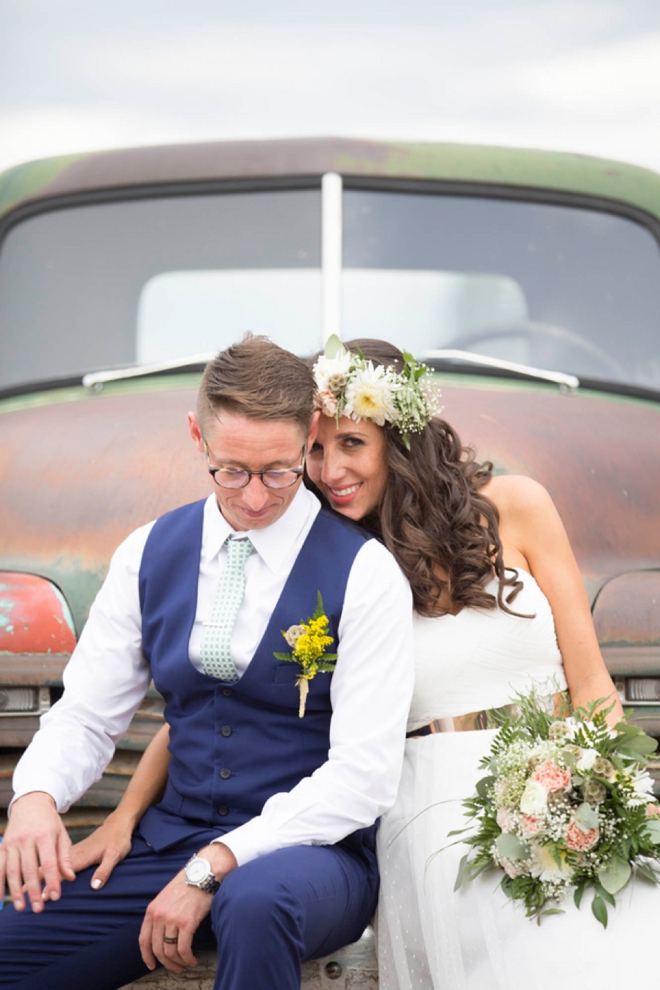 Bride and groom sitting on an old truck