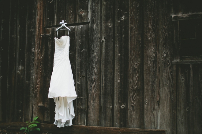 wedding dress hanging on barn