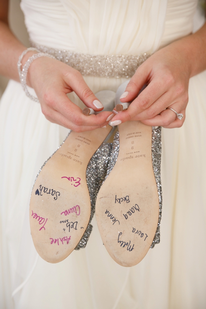The bridesmaids signed the bottom of her wedding shoes!