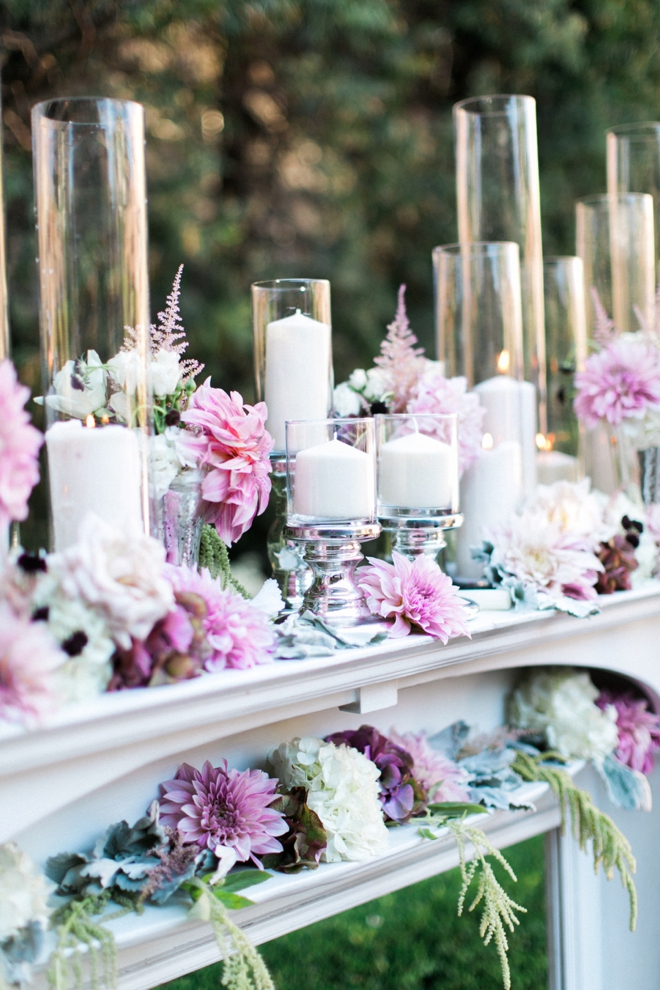 Gorgeous candles and flowers on a mantle for the ceremony