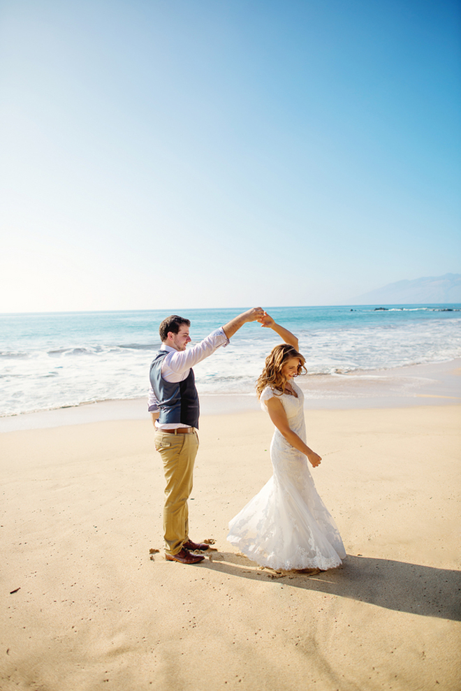 Bride and groom dancing on the beach