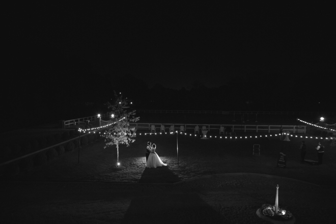 Bride and groom dancing at night, under the stars