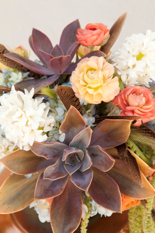 Boho-chic wedding bouquet with feathers and succulents