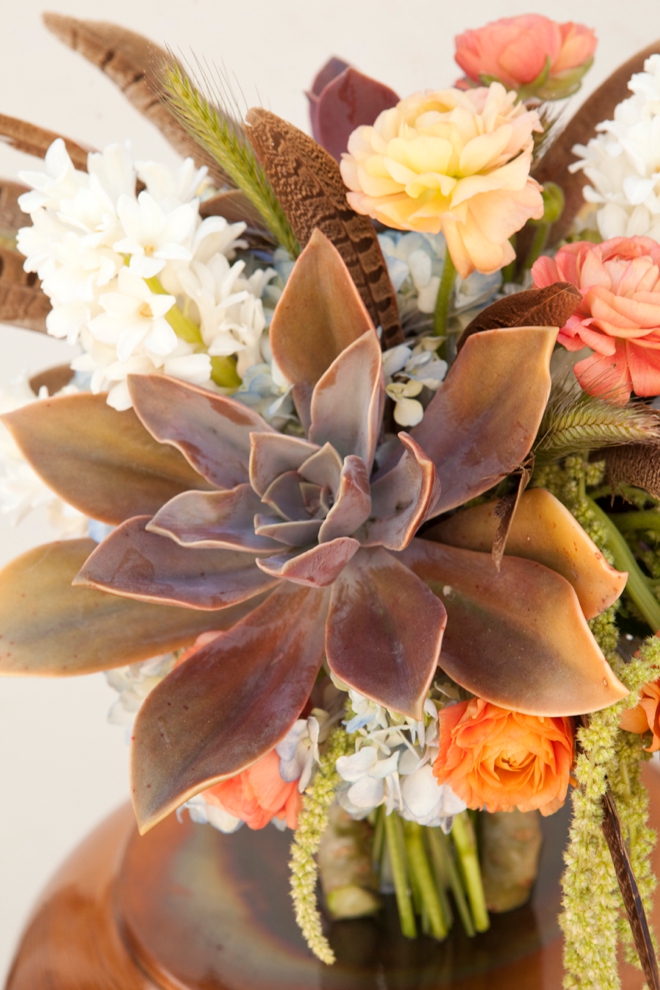 Boho-chic wedding bouquet with feathers and succulents