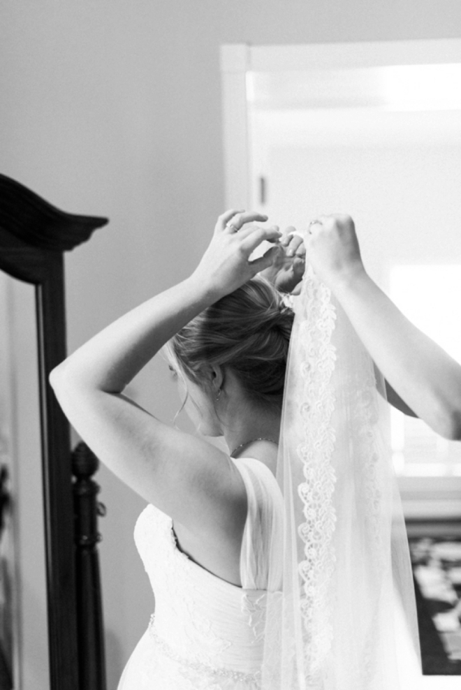 Bride putting on her veil