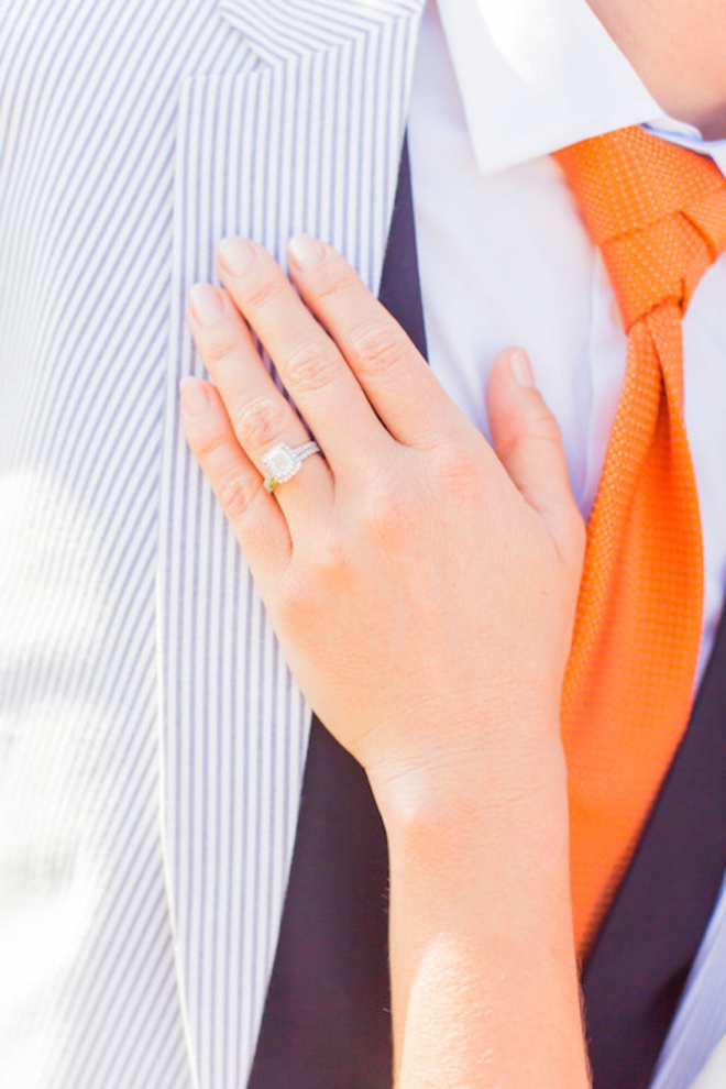 Wedding ring shot against grooms suit
