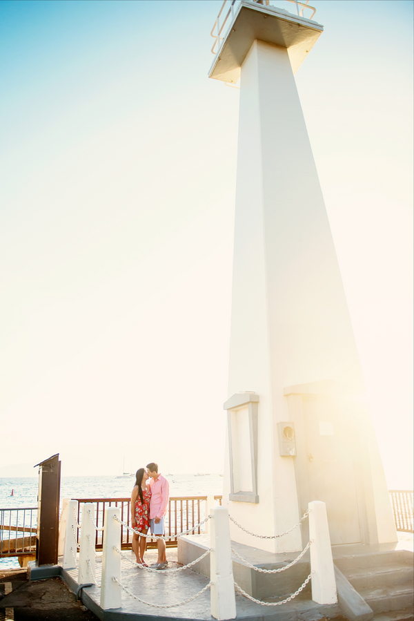 Gorgeous shot of a couple standing by a light house during their engagement shoot!
