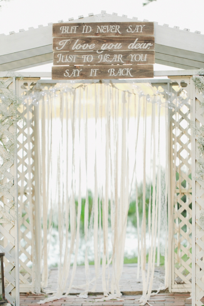 Ceremony backdrop with hand-painted sign