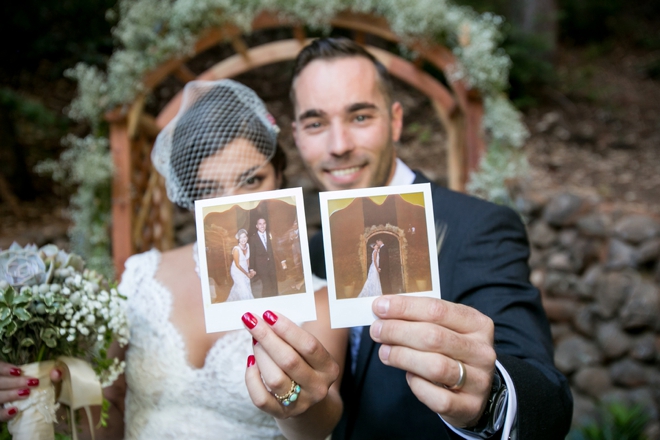 Bride and Groom holding polaroids of themselves