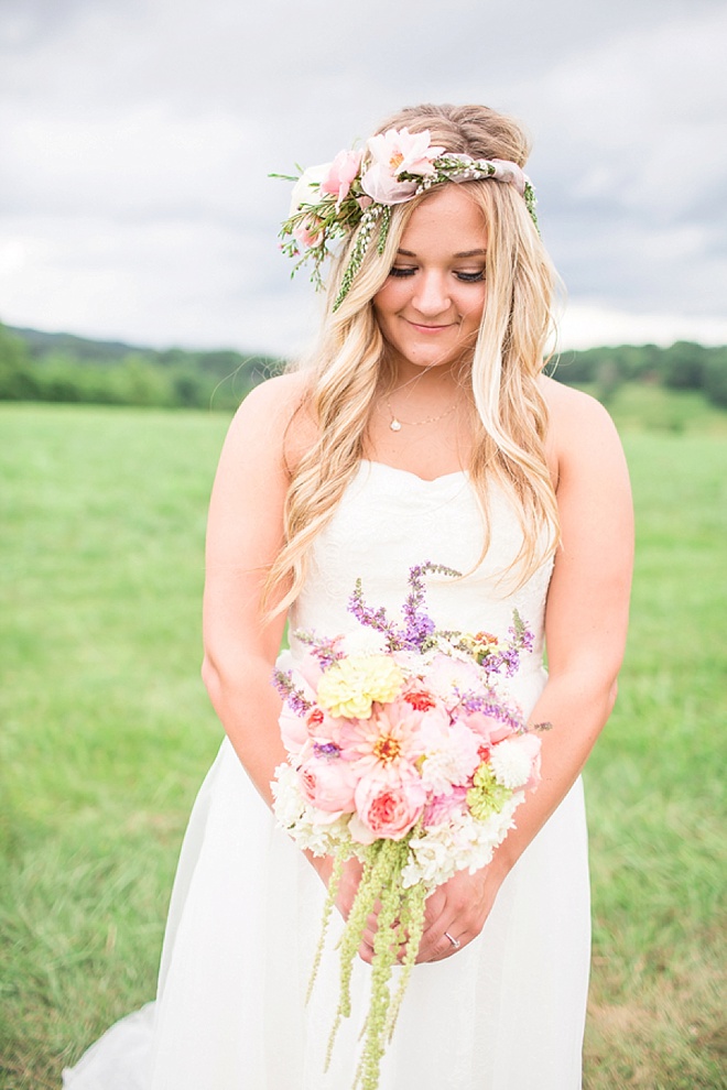 Bride holding gorgeous bouquet full of cabbage roses, hydrangea and amaranthus