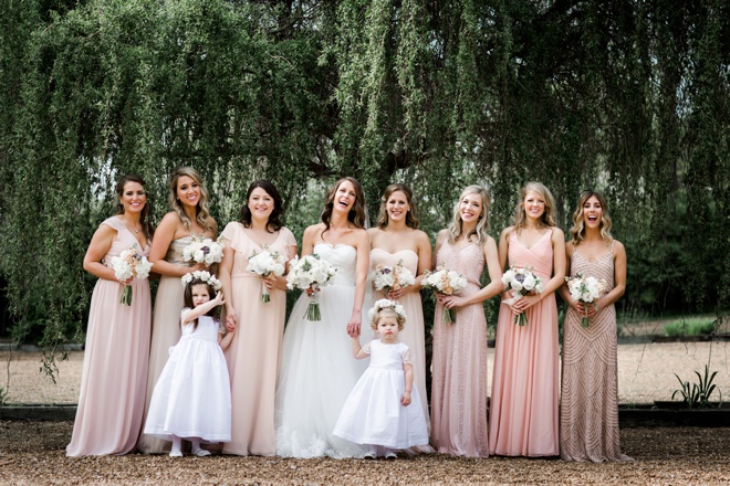 Stunning bridesmaids in mismatched pale pink dresses.