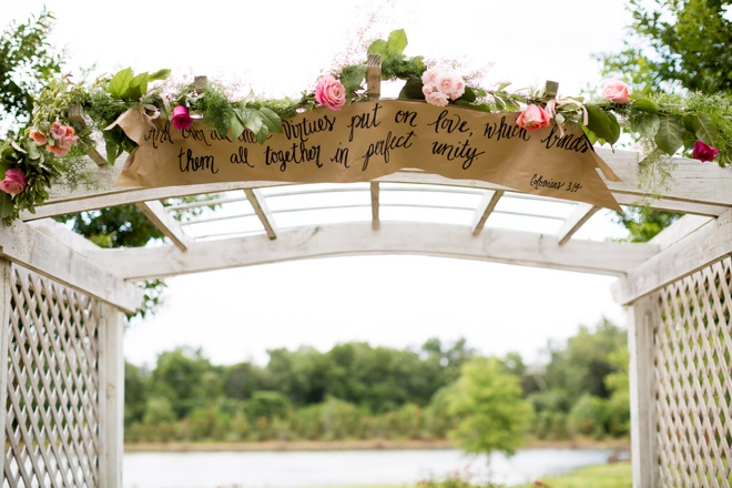 Amazing scripture sign hanging on the ceremony arch.