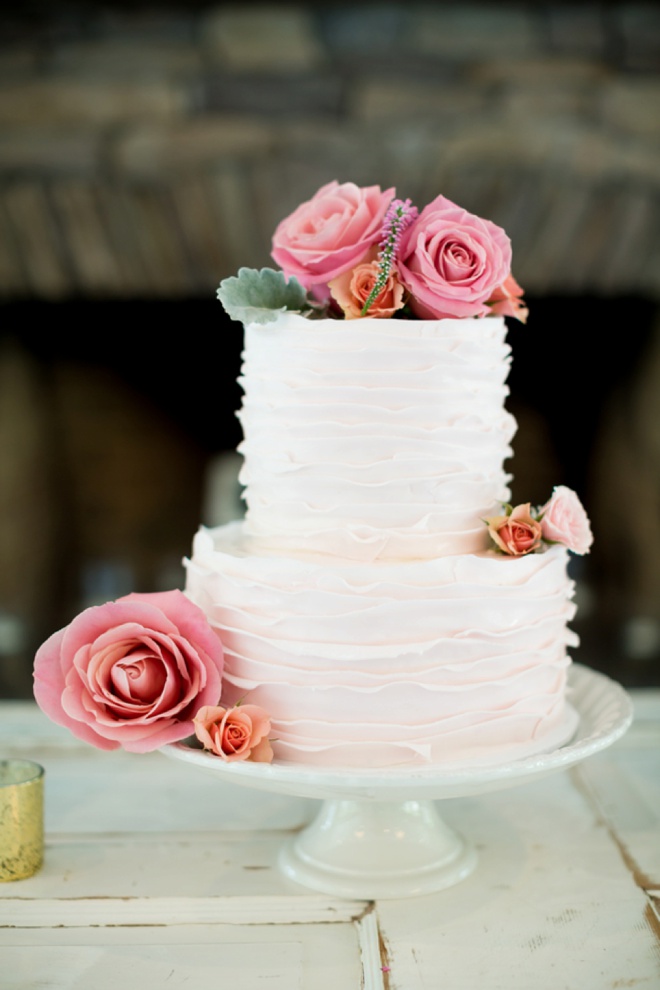 Beautiful ruffled cake embellished with flowers.
