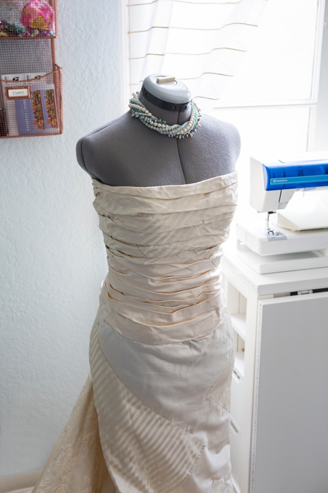 Jen's wedding dress on a dress form in her blog office.