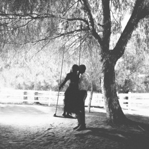 Super sweet kiss on a giant swing...