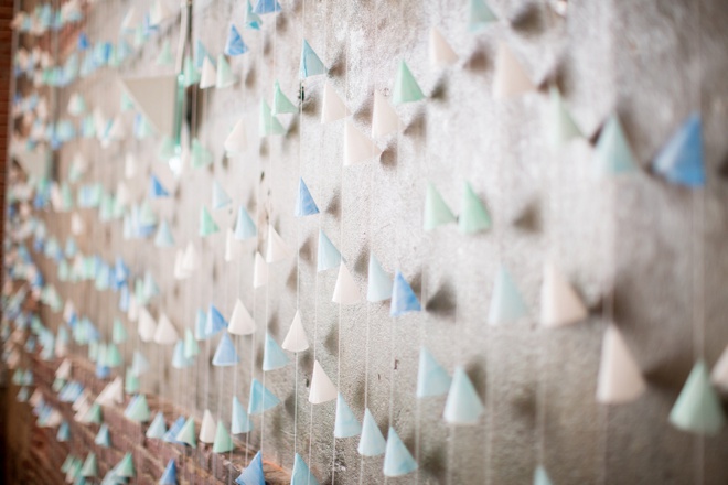 Awesome DIY colorful cone backdrop for wedding reception.