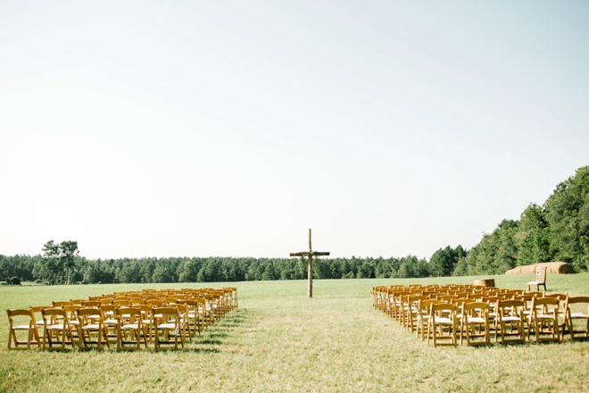 Stunning backyard wedding in front of a large handcrafted cross