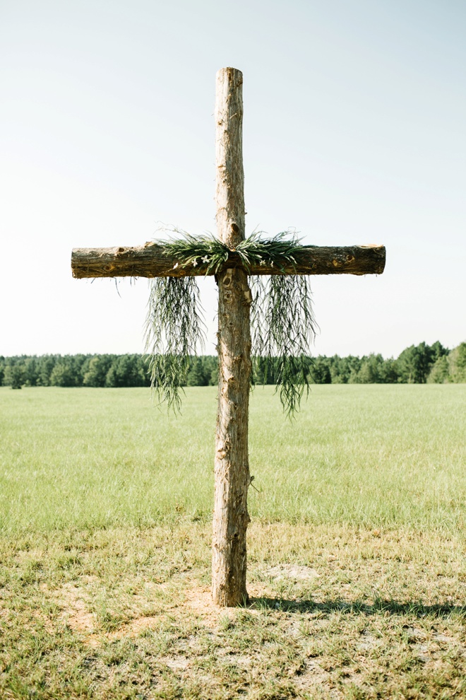 Stunning backyard wedding in front of a large handcrafted cross