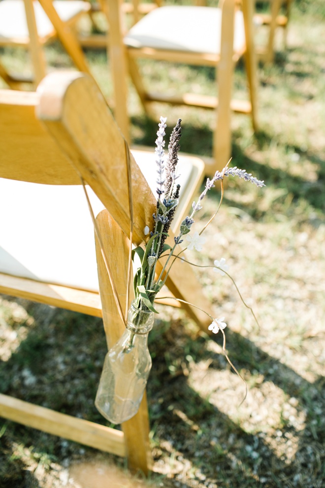 Ceremony seats tied with vintage bottles and sprigs of lavender.