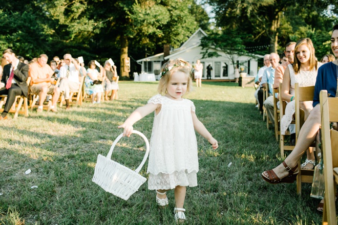 Darling flower girl making her way down the aisle