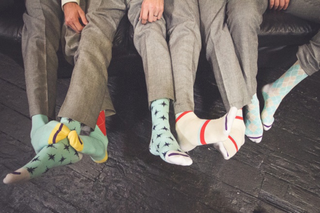 The groomsmen have colorful socks!