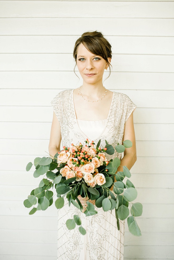 Gorgeous bride with her eucalyptus and peach rose bouquet!