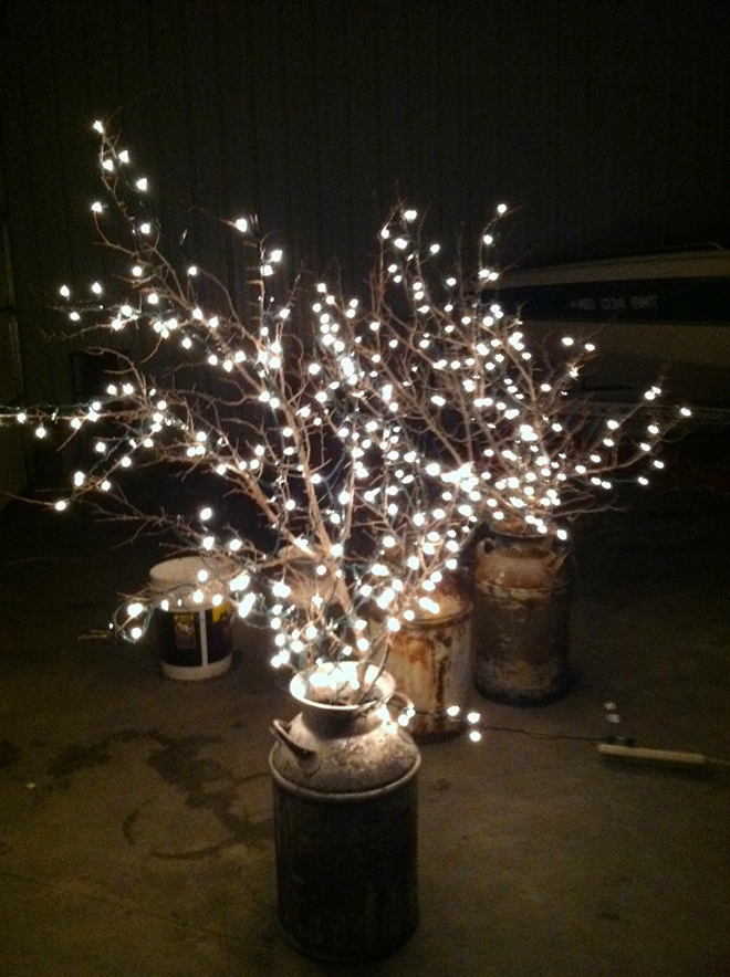 String Lights on branches in milk cans for budget friendly wedding decor