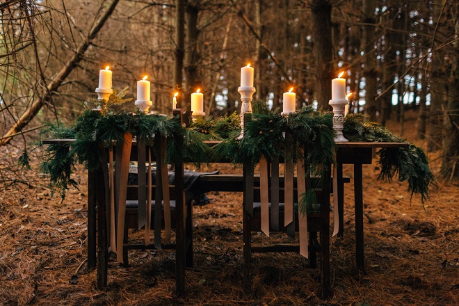Gorgeous candle lit romantic table in the forest