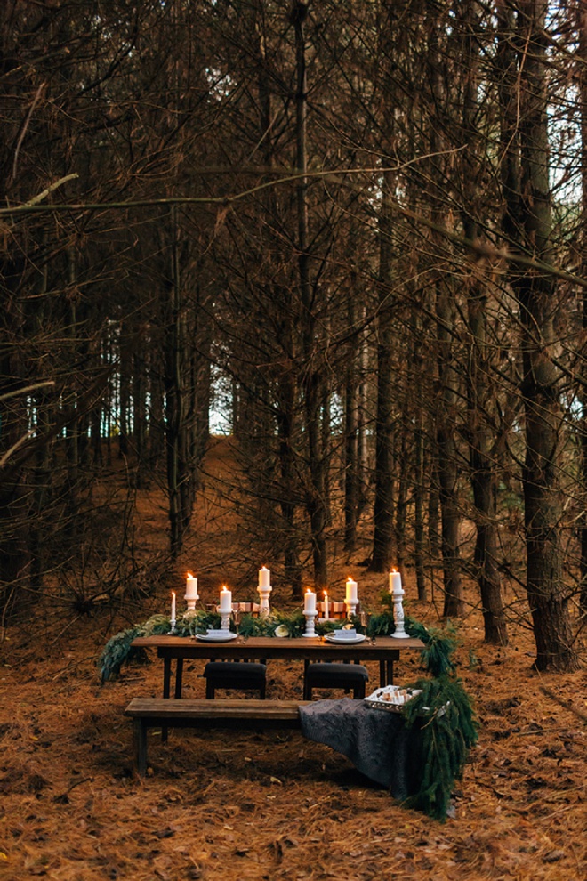 We love this gorgeous candle lit table in the forest!