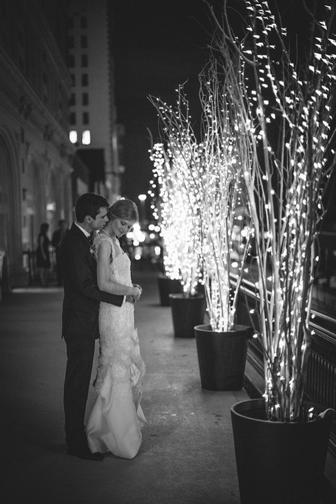 Pose for photos next to lit trees for a romantic look