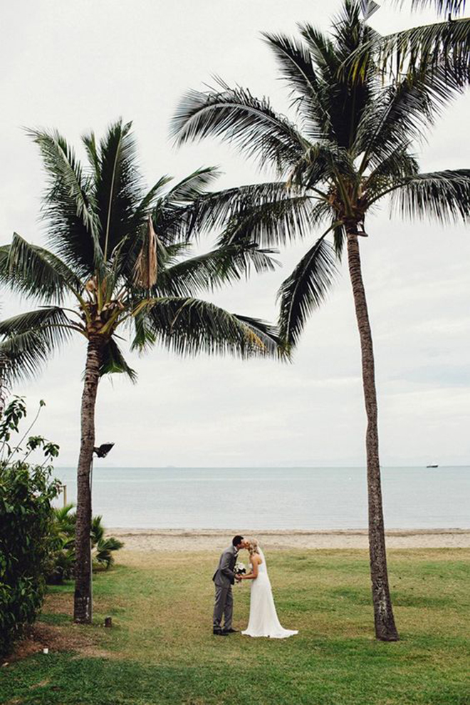 Tropical bride and groom kissing on the beach!
