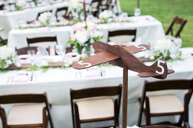 We're loving these adorable wooden airplane decor at this wedding!