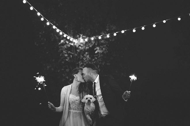 We love this darling sparkler photo with Bride, Groom and pup!