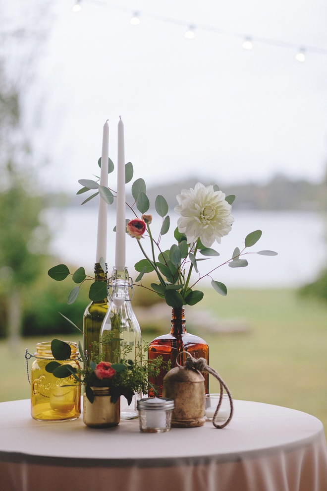Mismatched, hand painted bottles and flowers for cocktail table centerpieces!