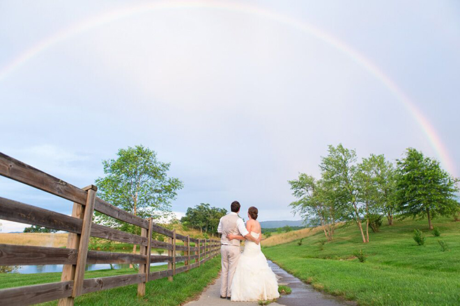 Amazing shot of bride and groom under a full rainbow!
