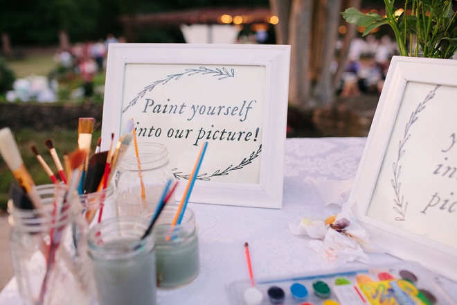 We LOVE this fun guest book idea! Guests paint themselves into the picture!